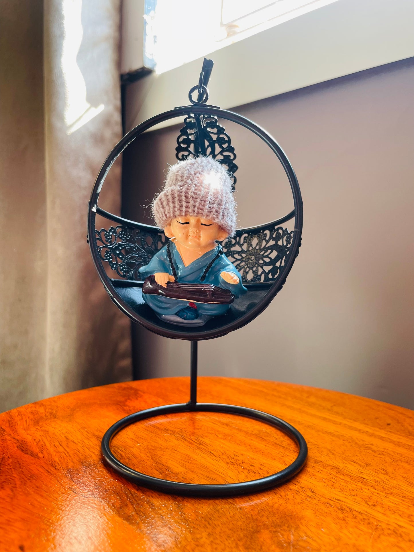 Baby Monk Buddha with Woollen cap on a Swing